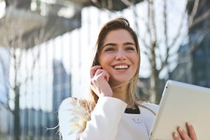A woman smiling while talking on the phone