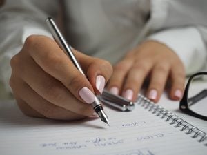 A making a list in a notebook