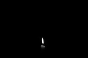 A lit candle in the absolute dark