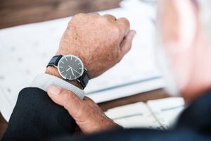 A businessman looking at his watch. 