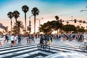 A lot of people crossing the street somewhere in Florida.