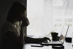 person sitting by lap top