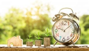 money and a clock as a sign for saving when moving abroad