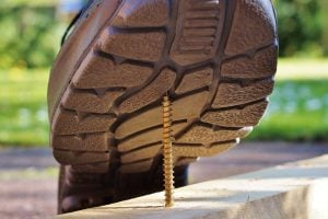 a nail and a shoe as a sign to prevent injuries on moving day