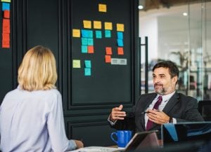 A man and a woman talking in an office