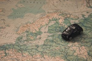 A figurine of a car on a map of Europe