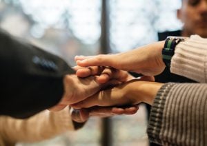 A number of people joining hands