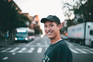 A man smiling on a street