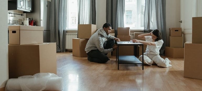 A couple disassembling a table