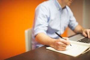 Man writing on the notebook