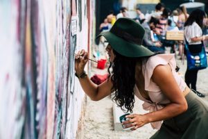 A girl painting on a wall