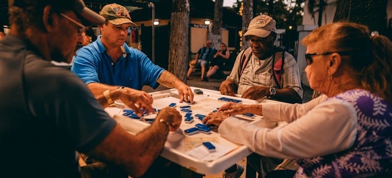 A group of four people playing Mahjong in Miami