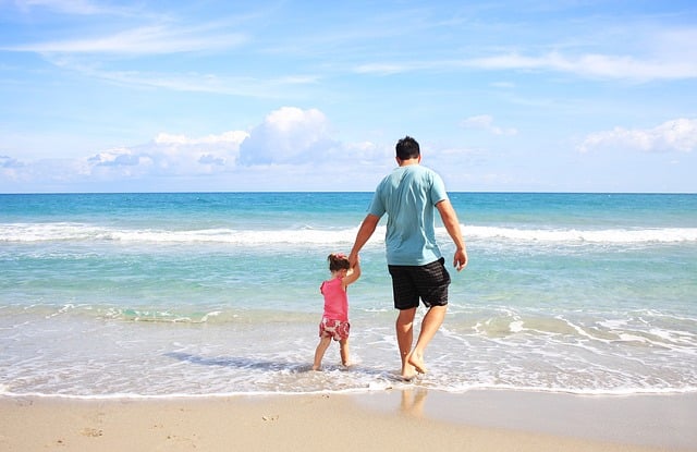 Father and daughter enjoying beach.