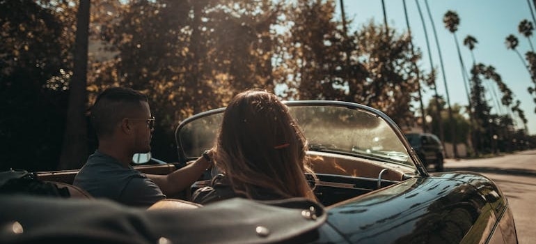 A couple in a convertible heading to fun activities in Hollywood FL