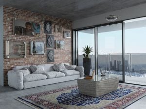 A living room in an apartment with a big window.