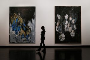 A person walking through an art gallery.
