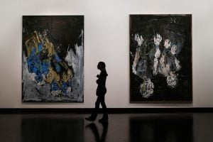 A person walking through an art gallery.