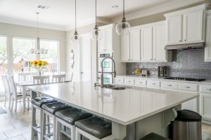 Contemporary white kitchen. The kitchen is one of the rooms you should unpack first after you move in.