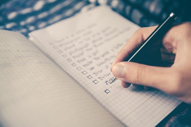 Man writing down tips on how to remodel your basement for a living