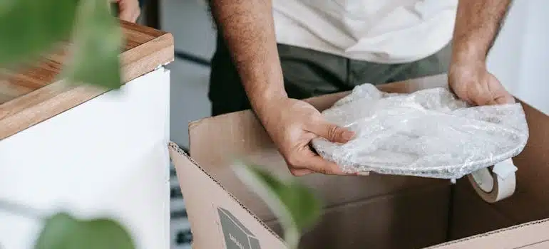 A man shows how to pack your kitchen for a long-distance move