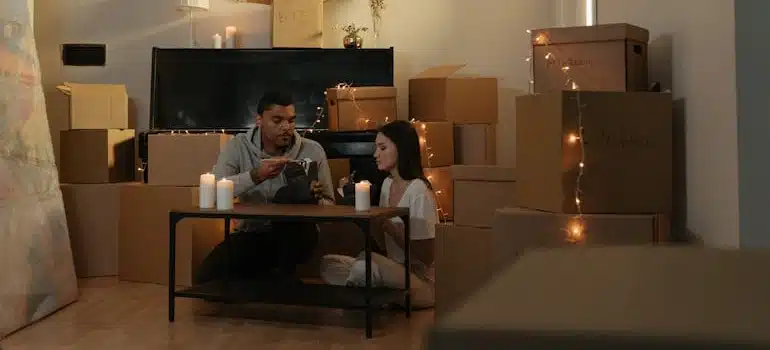 A couple eating amid boxes after successfully connecting utilities