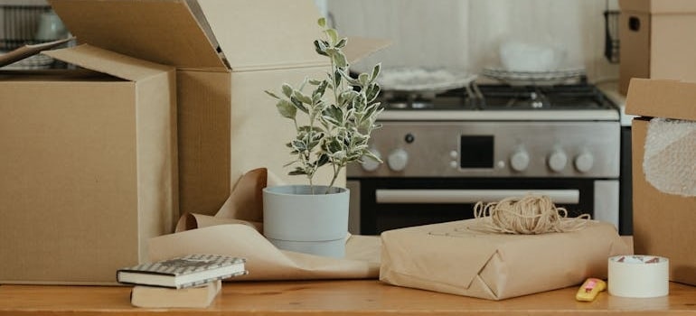 Brown Cardboard Boxes on Brown Wooden Table