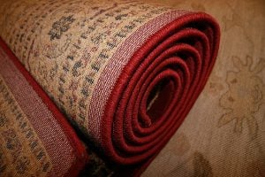 A red rolled up rug