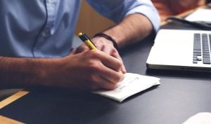 Man writing tips on moving rugs and carpets.