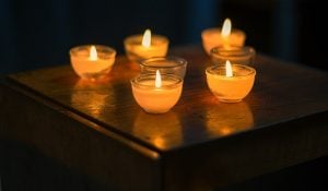 Five small candles on a table.