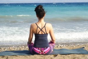 Woman doing yoga to de-stress after a move in Miami.