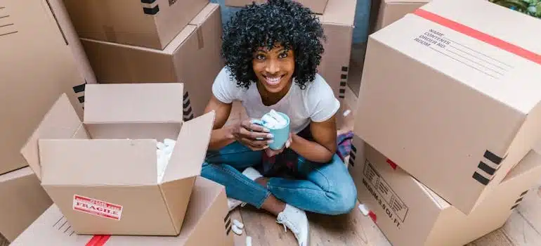 A woman holding a blue ceramic mug full of packing peanuts