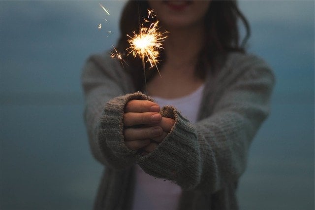 Woman holding a sparkler to celebrate NYE in Miami