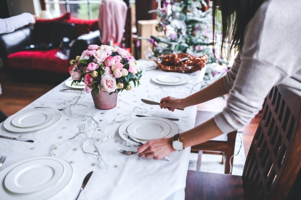 Woman setting a table for a dinner party