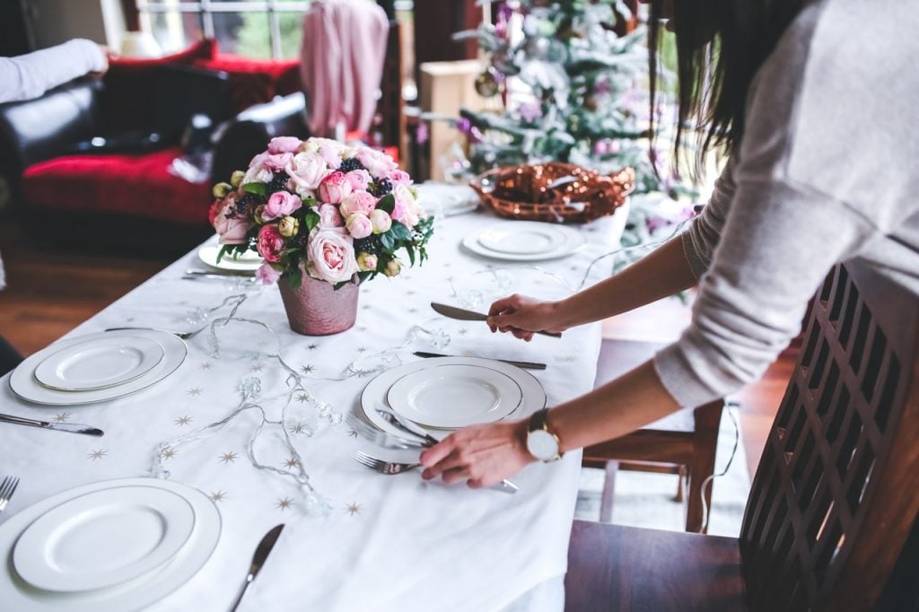 Woman setting a table for a dinner party