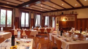 a hall with tables and chairs decorated and ready for dining