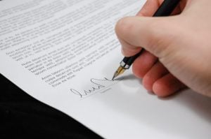 person signing a document 