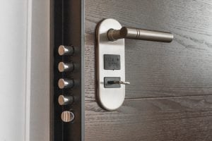 metal keyhole and a door handle on wooden door