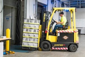 man riding a yellow forklift