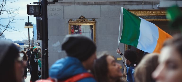 man holding an Irish flag on St Patrick's Day