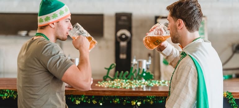 2 men drinking beer at St. Patrick's Day in Miami