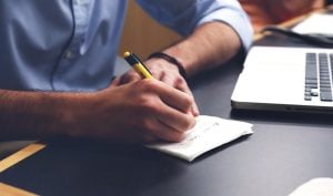 person writing in a notebook