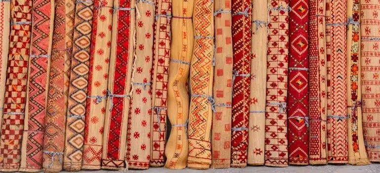Rolls of traditional carpets placed upright