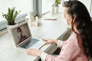 woman wearing mask and having a video call