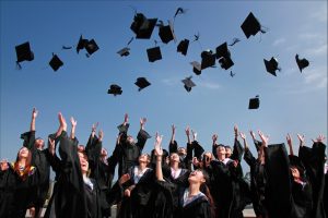 student throwing graduation caps in the air