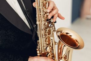 a musician holding a saxophone, before preparing instruments for storage in Miami