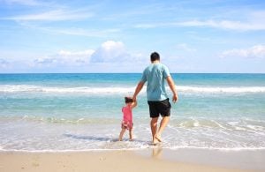 a father and daughter on a beach