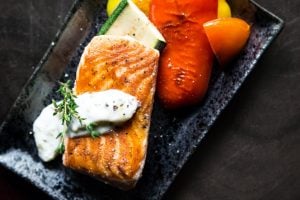 grilled salmon on a black plate