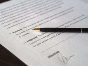 a contract and a pen placed over it