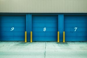 A photo of three storage units with blue doors and numbers 9, 8, and 7 on them