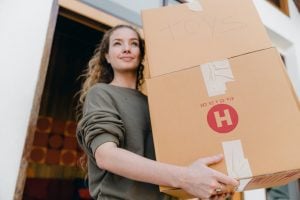 A woman carrying boxes for storage